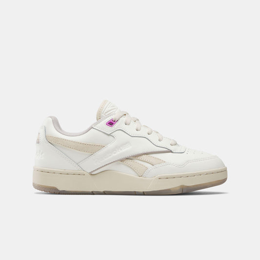 Off-white low-top sneaker with white laces and a pink accent near the tongue.