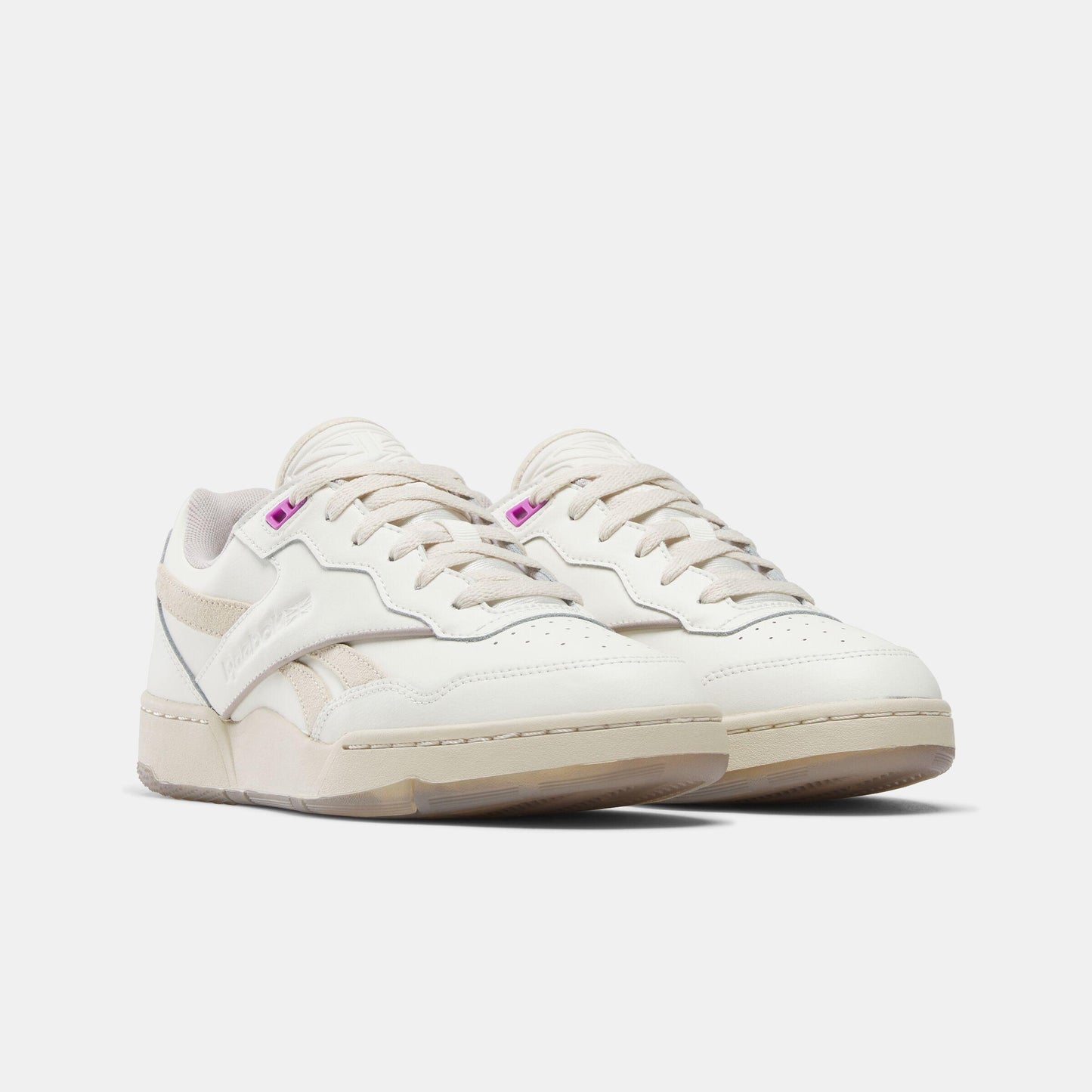 Off-white sneakers with lace-up closure and perforations.