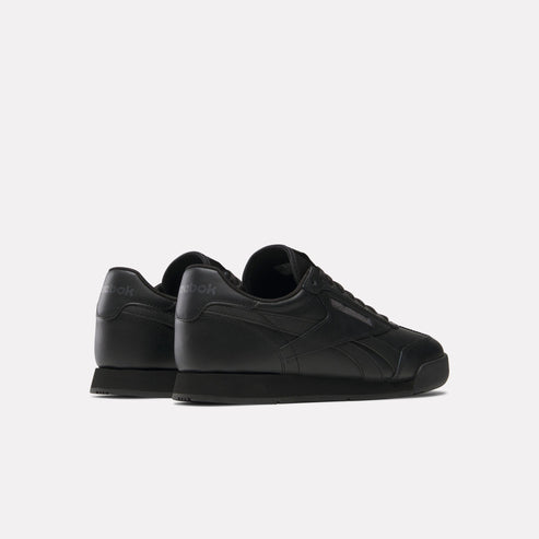 Low-profile black leather sneaker, side profile.