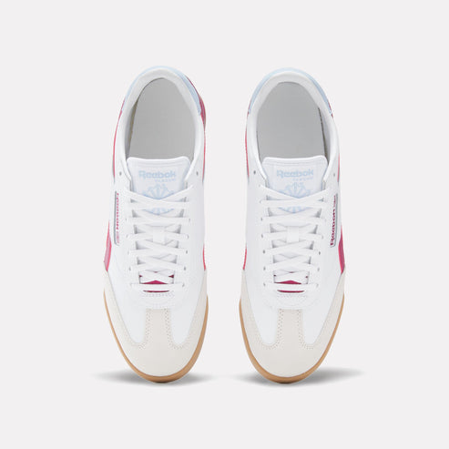 Top-down view of white sneakers with white laces, a gum sole, and pink accents, featuring the text "Reebok CLASSIC".