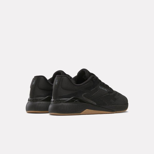 Pair of low-rise athletic shoes in solid black with a brown sole.