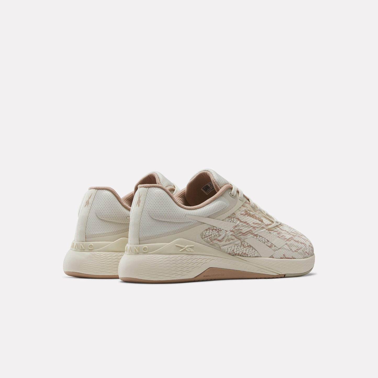 Rear view of a low-profile training shoe in off-white with map pattern details, featuring beige interior and tan sole.