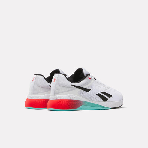 Low-profile sneakers in white with black accents and red/teal soles. 