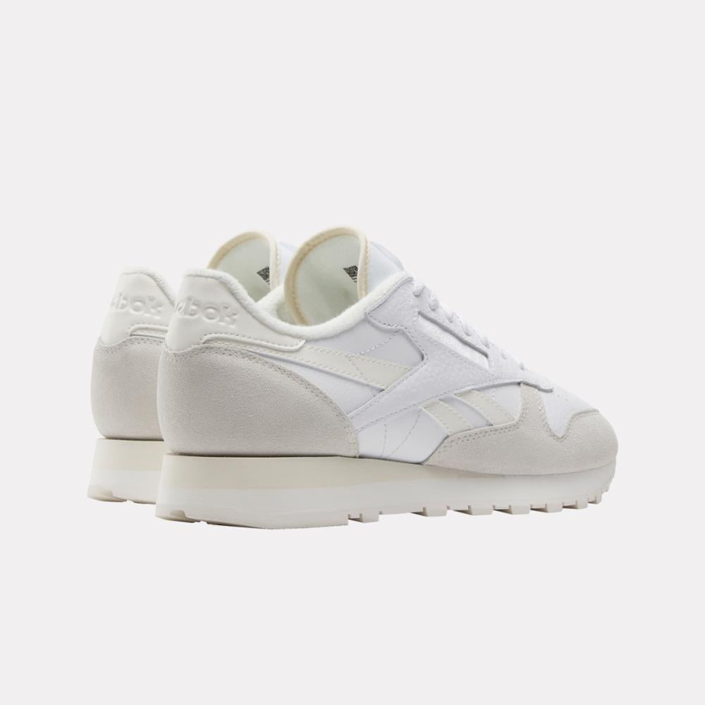 Low-top sneaker, white with light-gray suede, rubber outsole.