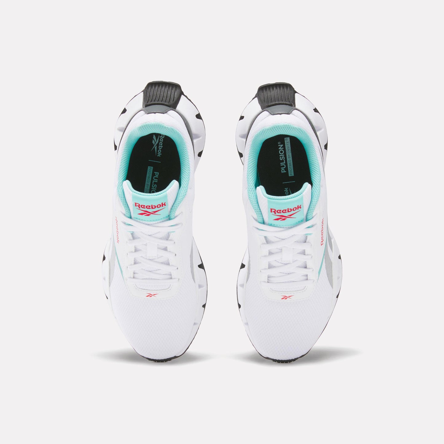 A pair of white sneakers with teal and coral accents, facing forward.