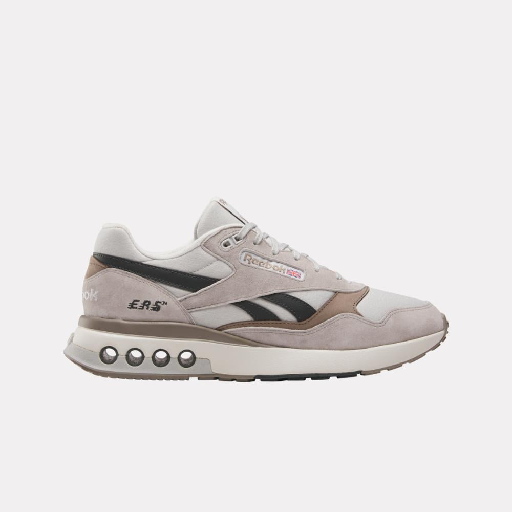 A low-top running shoe in light gray and black with visible 'ERS' and the Reebok logo.