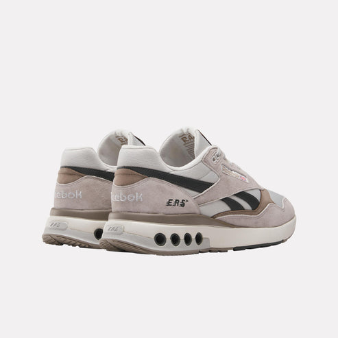 Rear view of Reebok gray, black, and brown sneakers with ERS printed on side.