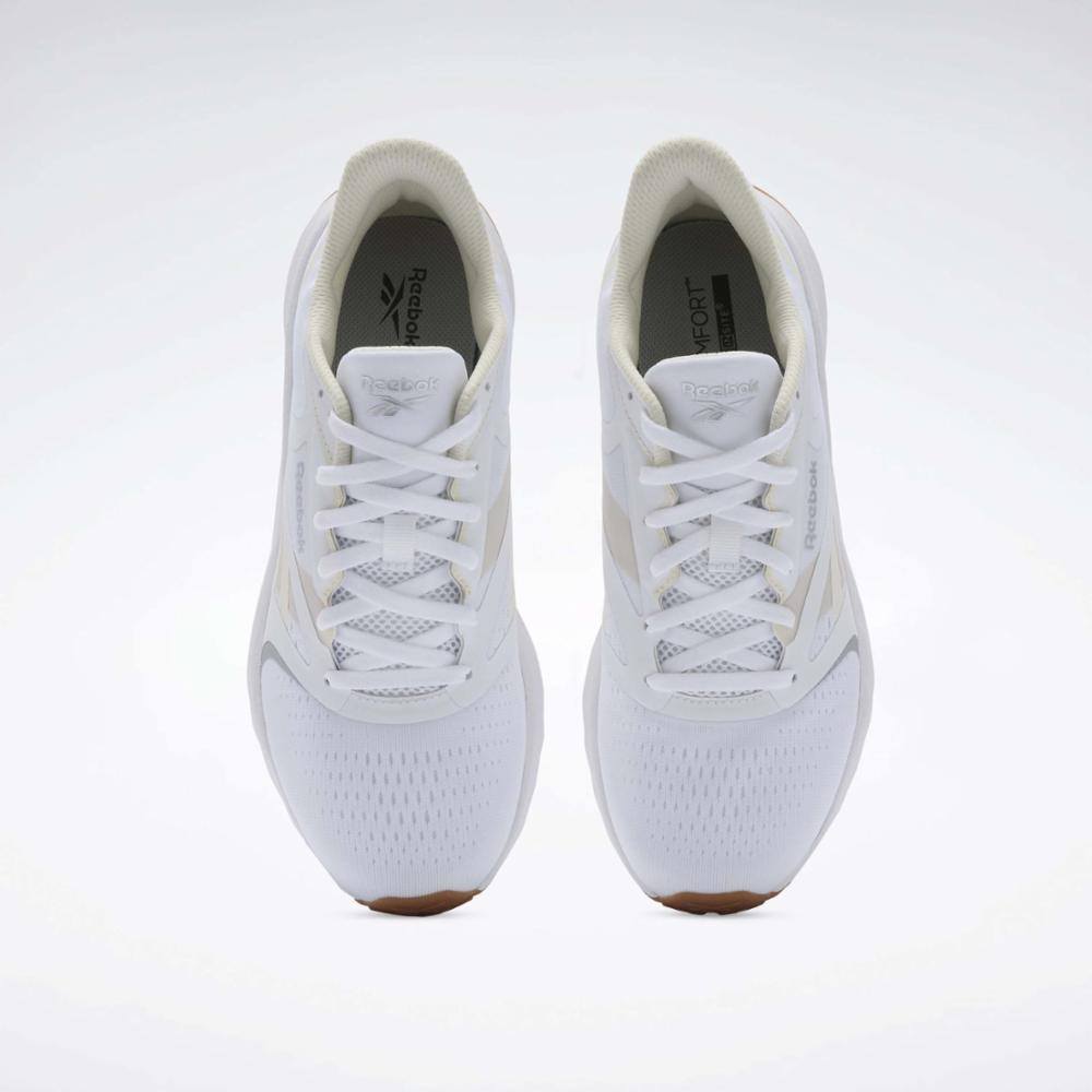 Two white athletic shoes with white laces, seen from above.