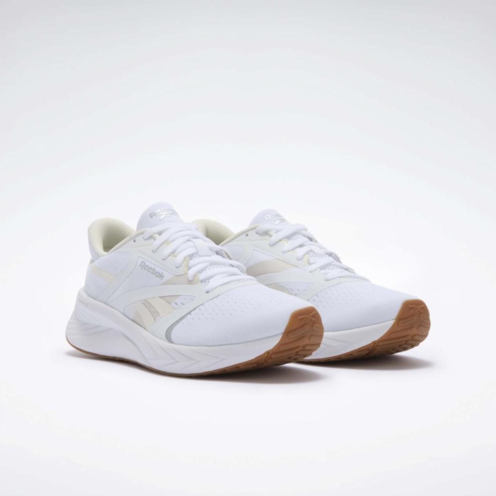 Pair of white sneakers with gum soles and white laces.