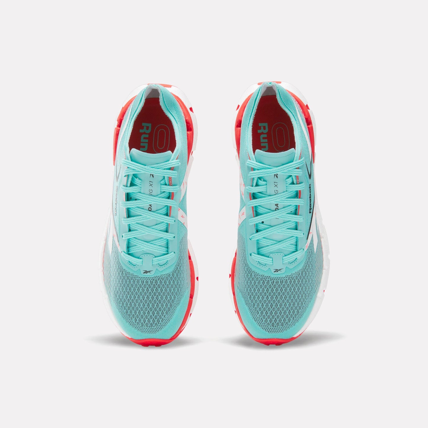 Two light blue athletic running shoes with white laces and red interior lining.