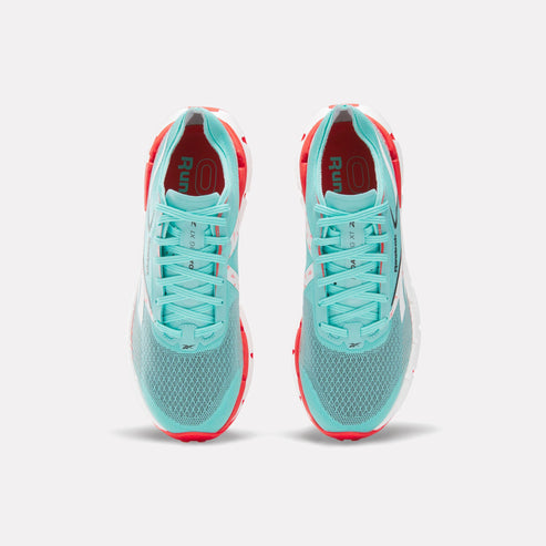 Two light blue athletic running shoes with white laces and red interior lining.