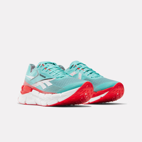 Turquoise sneakers with white side logo and red sole.