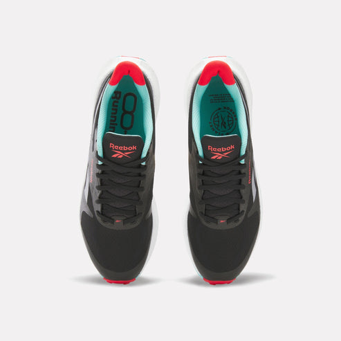Overhead view of two athletic shoes. Both shoes have a black upper with black laces, a white midsole, and a red and white outsole. The shoe linings are teal, and "Reebok" is written on the tongue in red.