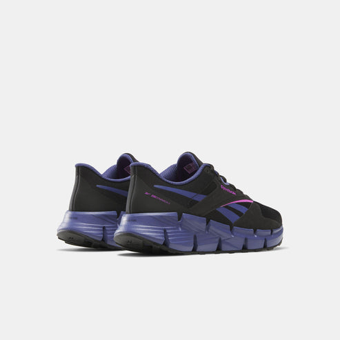 Pair of black athletic shoes with purple soles and pink accent.