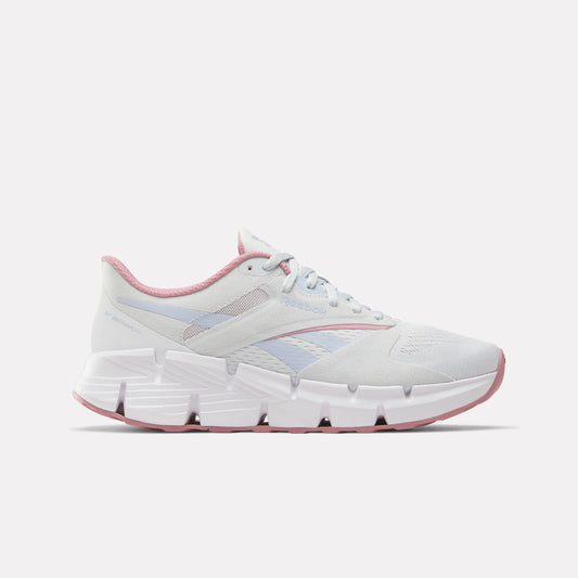 White athletic shoe with pink trim and visible geometric sole.