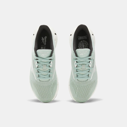 A pair of mint green running shoes with black interior linings and white soles.