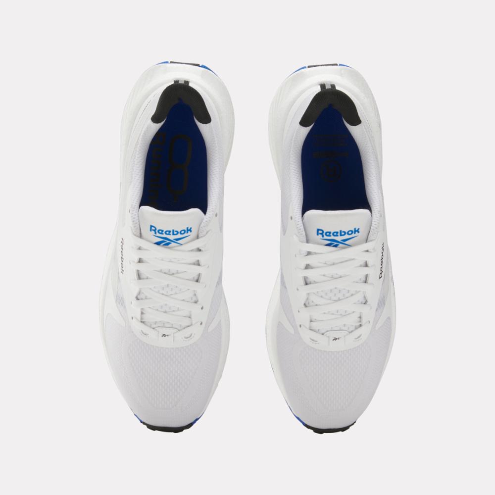 Top-down view of white running shoes with blue and black accents and white laces.