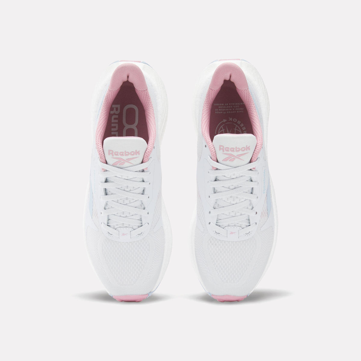 Top-down view of two identical white running shoes with white laces and pink lining.
