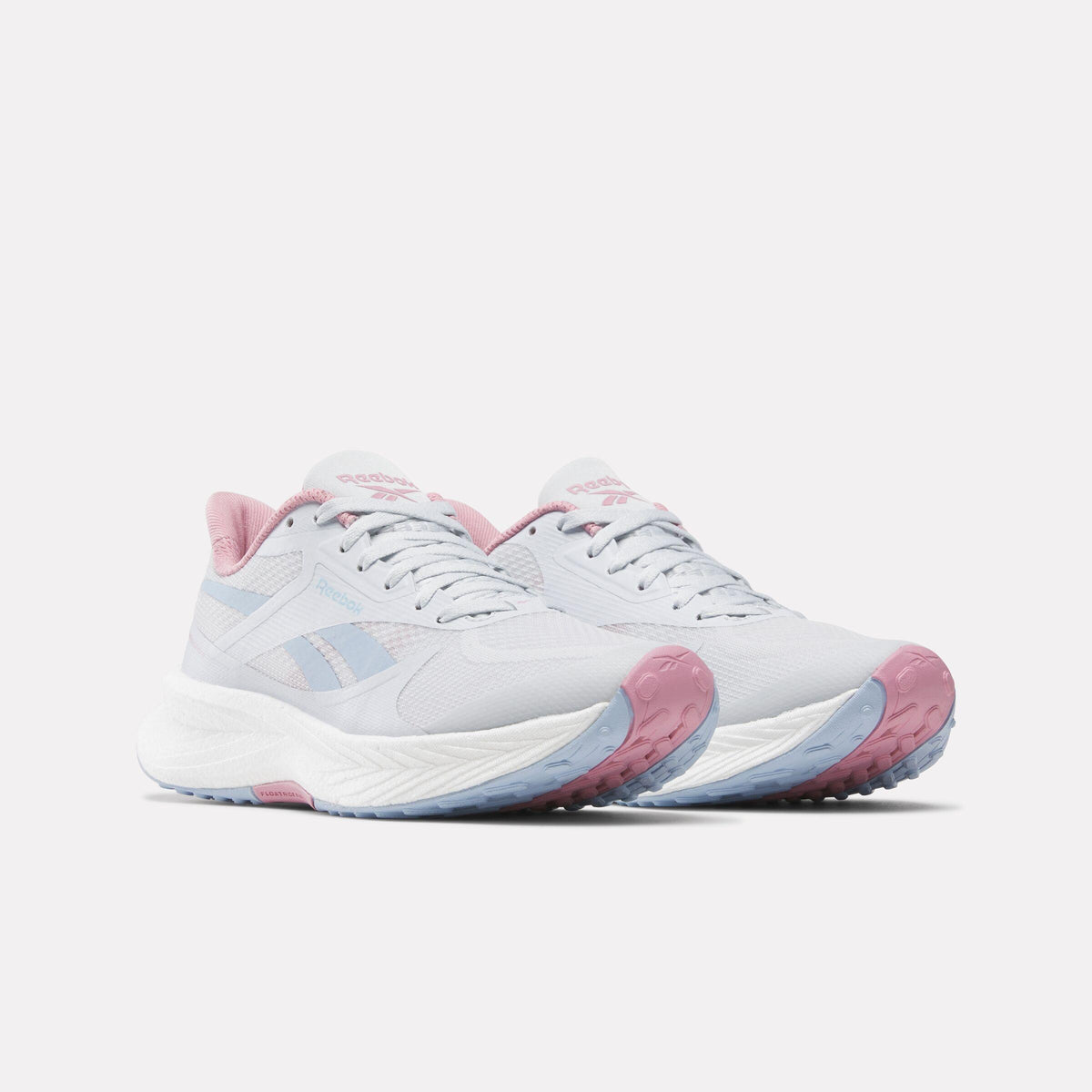 A pair of light grey running shoes with pink accents on the heel and tongue.