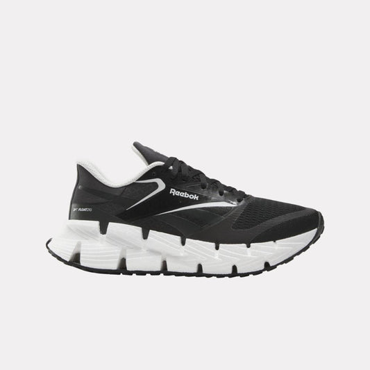 Black running shoe with a white zig-zag patterned sole and white accents.