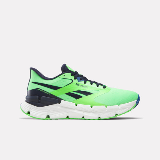 A low-top running shoe is light green with dark blue accents and a white midsole. The word "Reebok" is on the side.