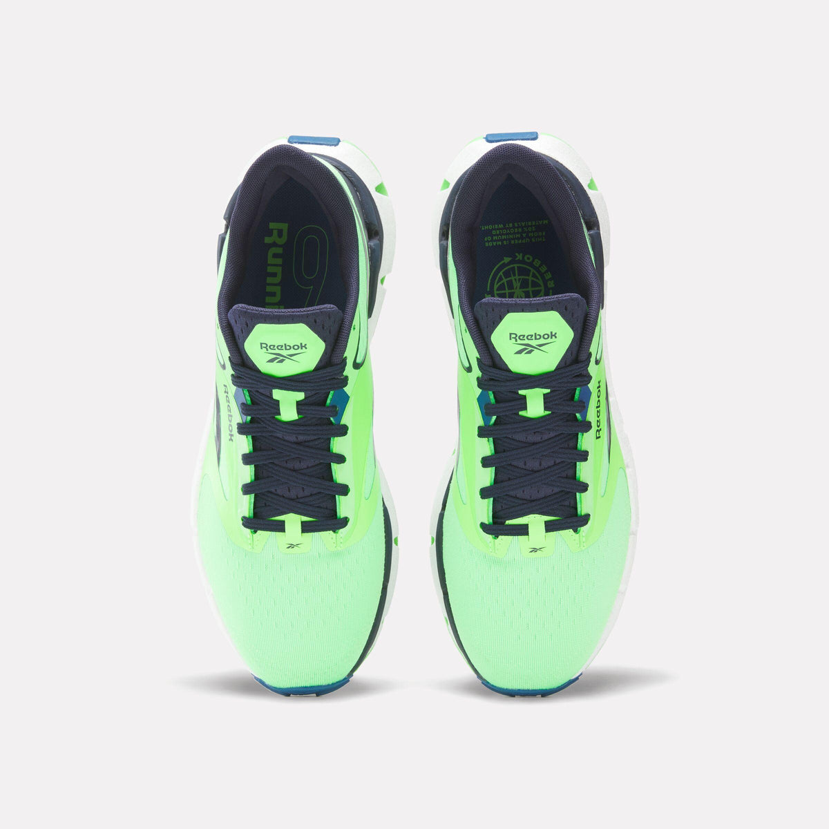 Overhead view of two light-green running shoes with dark-blue laces and inner lining; the shoe tongue has a small logo on it and the insole says 'Run'.