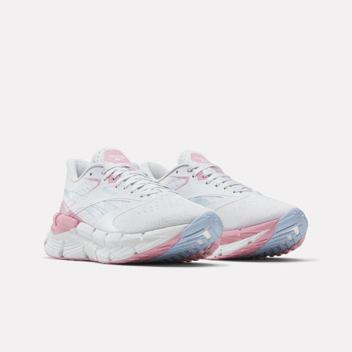 Pair of white athletic shoes with pink and blue accents.