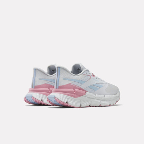 Pair of white sneakers with pink and blue accents, showing the back of the shoes with distinctive segmented soles.