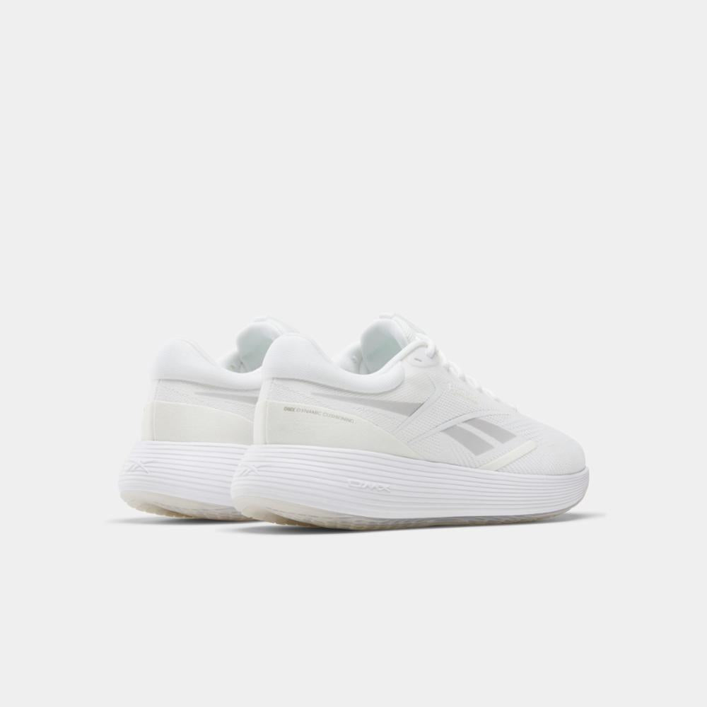 White athletic shoes with low profile, thick ridged soles and a side logo.