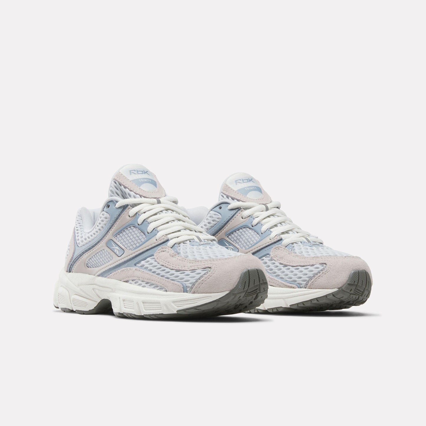 Pair of athletic shoes with white laces, blue and gray accents, and a chunky white sole.
