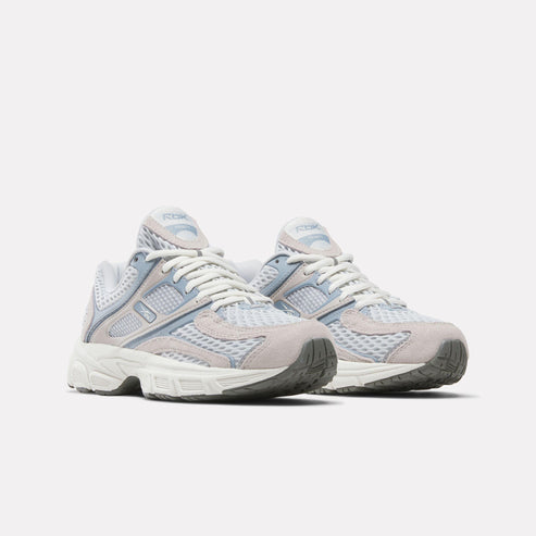 Pair of athletic shoes with white laces, blue and gray accents, and a chunky white sole.
