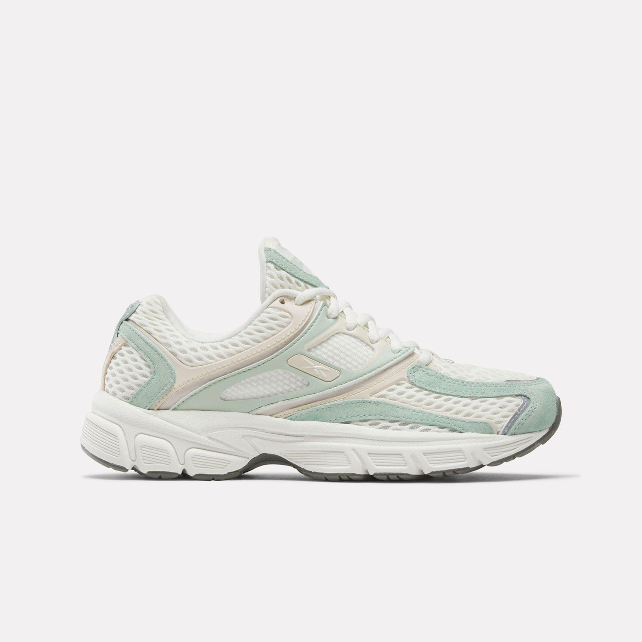 Low-top sneaker in white and light green with mesh and synthetic leather overlays and a chunky sole.