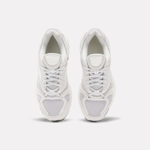 Two white sneakers with white laces facing forward.