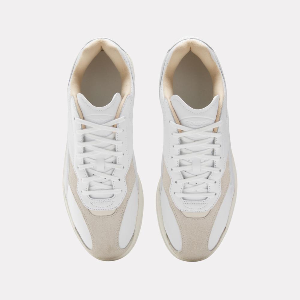 Pair of white sneakers with off-white suede toe and heel.