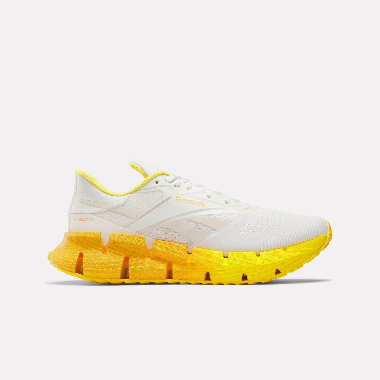 White sneaker with yellow zigzag sole.