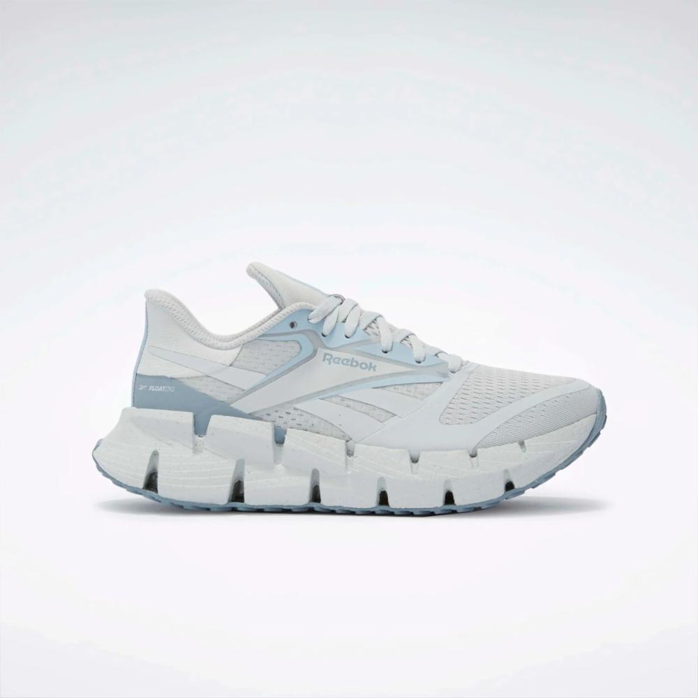 White running shoe with a zigzag patterned sole.