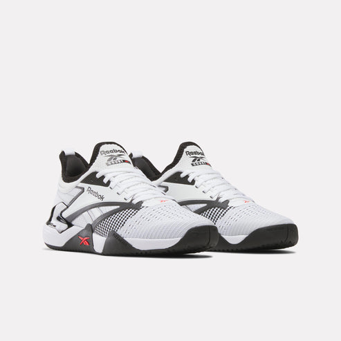 Pair of white and black training shoes; the visible text is "Reebok ELEVATE".