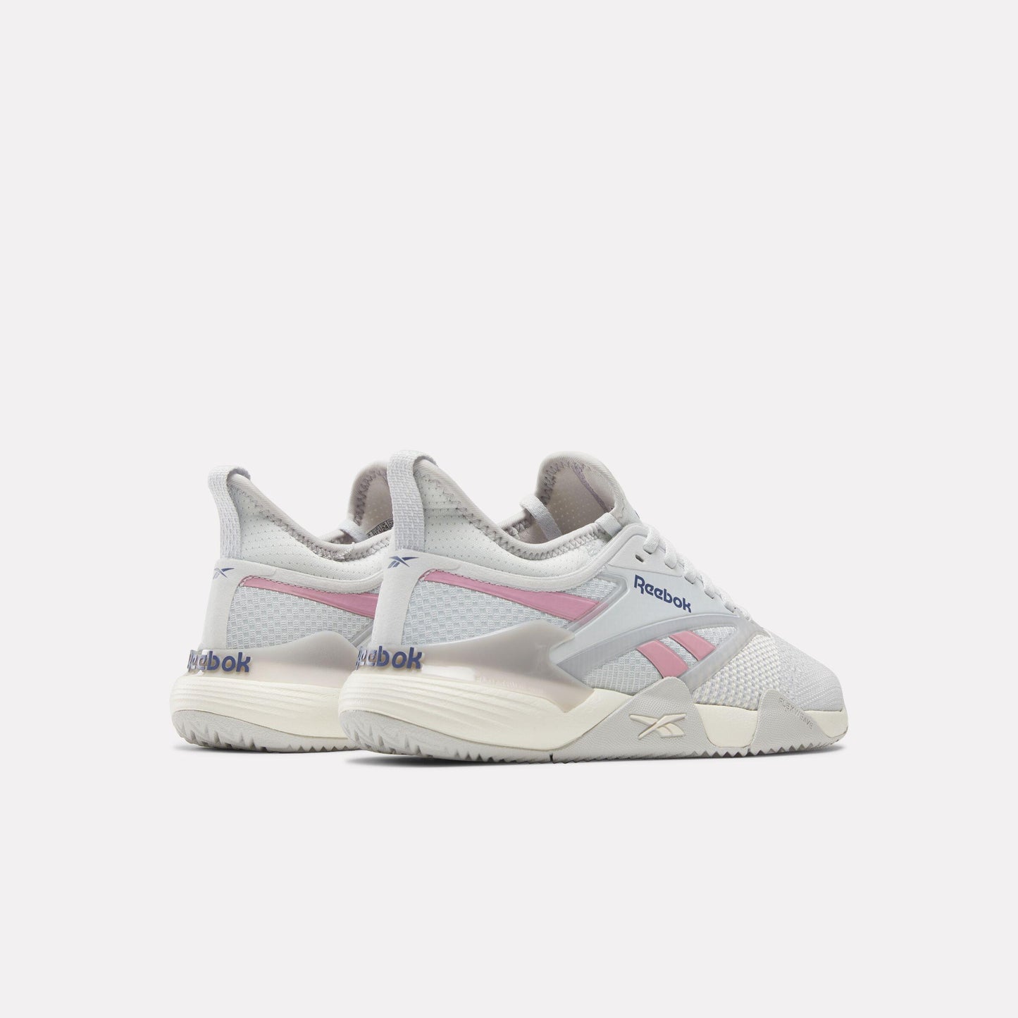 pair of off-white athletic shoes with pink accents and light gray trim