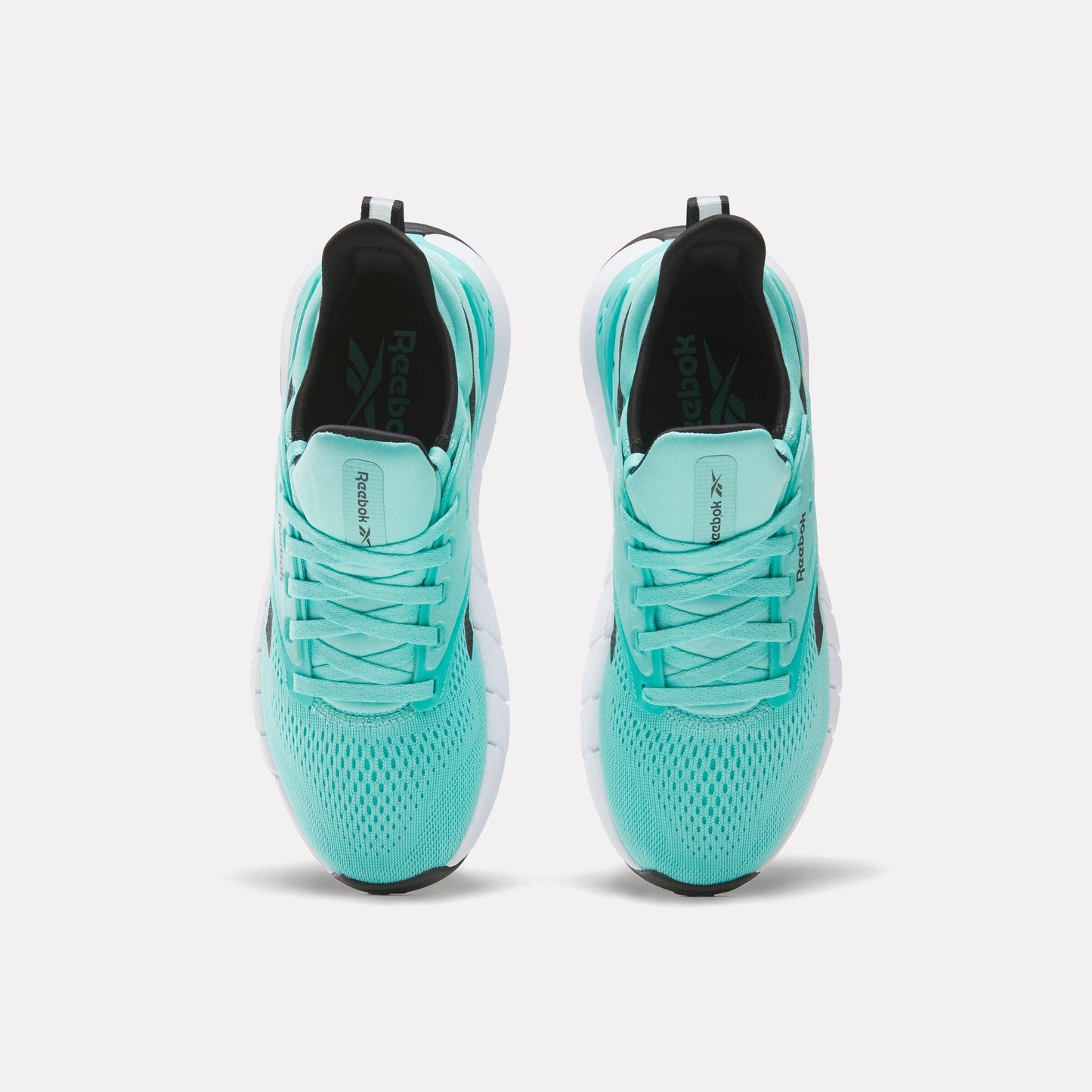 Top-down view of turquoise athletic shoes with black interior and white midsole.