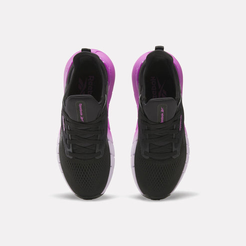 A pair of black sneakers with purple heel, top-down view.
