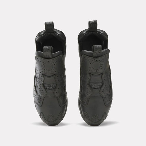 Pair of low-rise, all black, shoes viewed from the front.