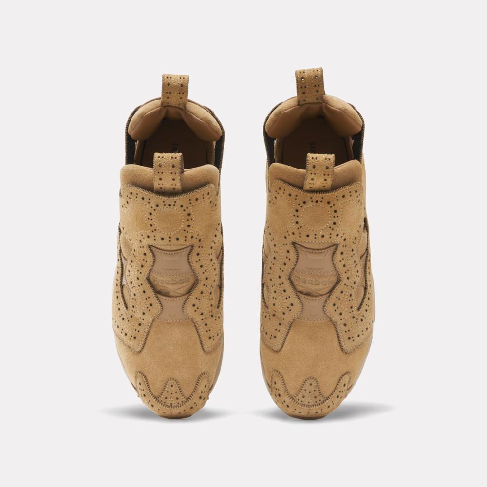 Two tan colored shoes with small hole detailing facing up.