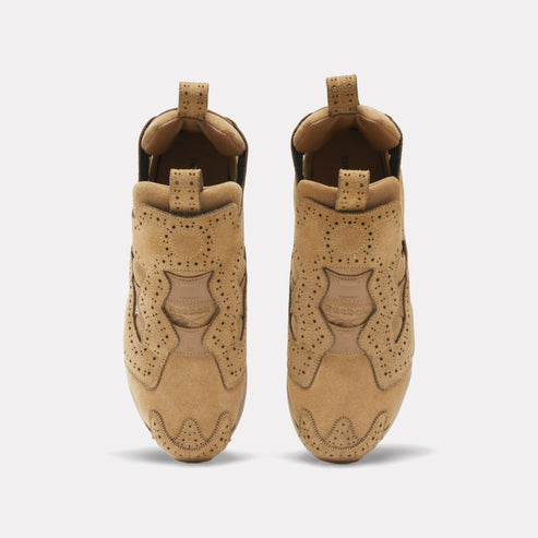 Two tan colored shoes with small hole detailing facing up.