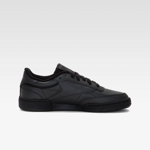 Black low-top sneaker with a leather upper and lace-up closure.