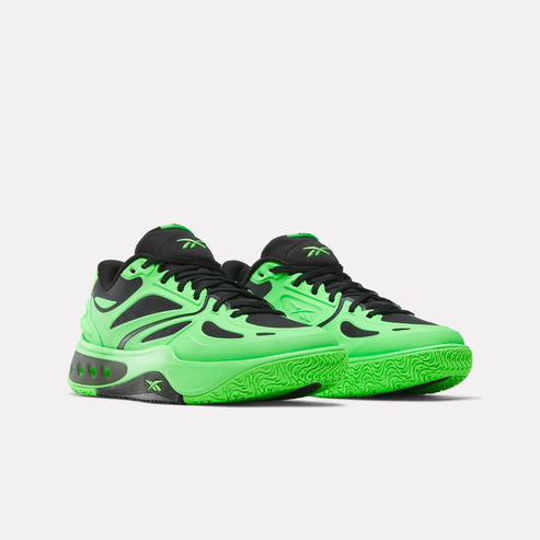 Low-cut basketball sneakers in black and bright green with jagged soles.