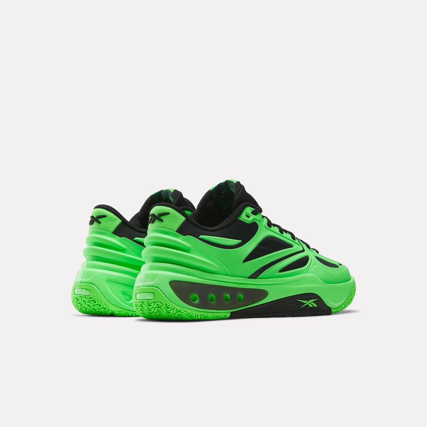 Bright green and black basketball shoes with black laces and black logo on the outsole.