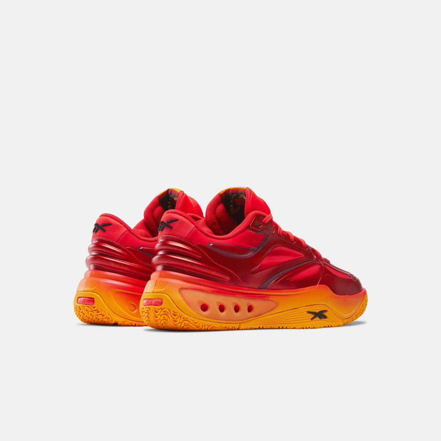 Red athletic shoes with an orange sole.