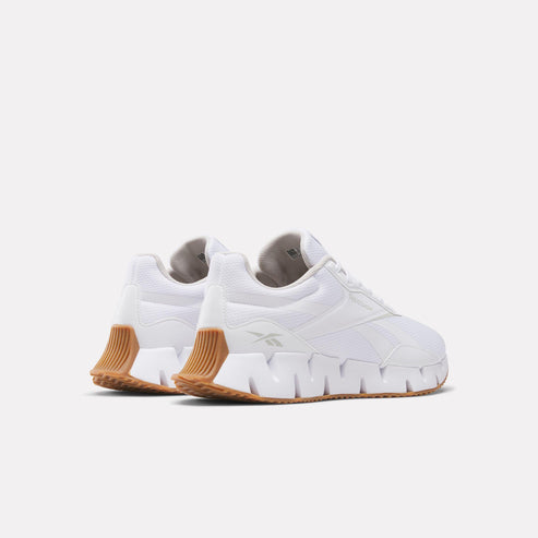 White sneakers with a zigzag textured sole.