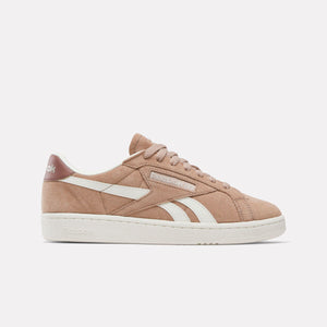 Tan leather sneaker with white sole and stripe, and laces.