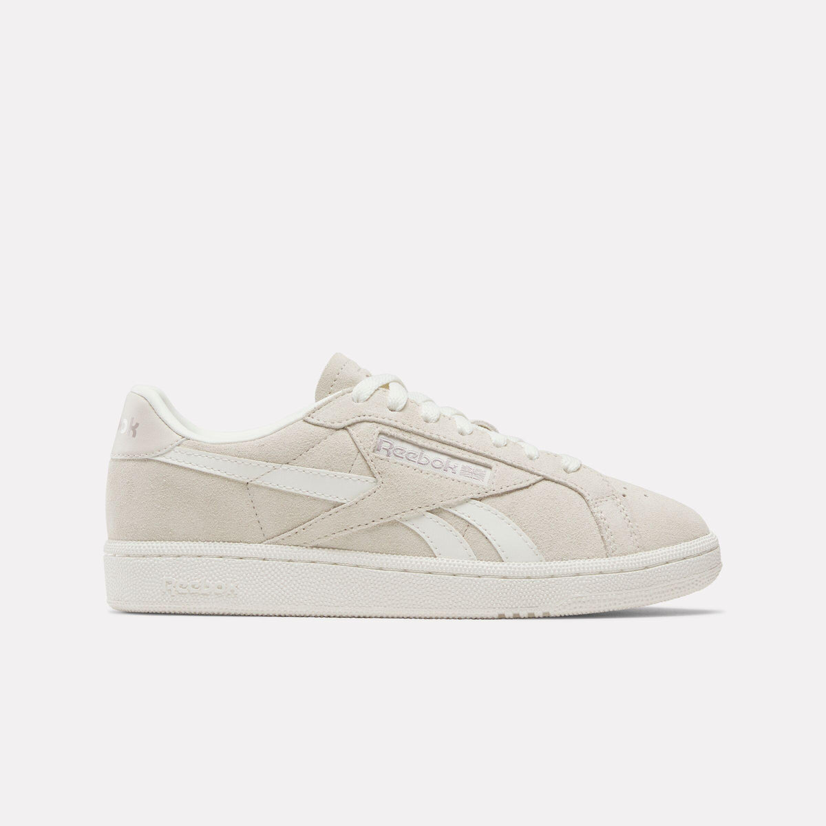 Low-top, off-white sneakers with white laces and stripes.